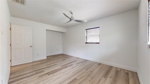 empty room featuring ceiling fan and light hardwood / wood-style floors