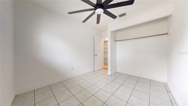 unfurnished bedroom featuring ceiling fan and a closet