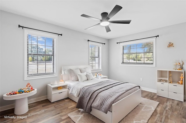 bedroom with wood-type flooring and ceiling fan