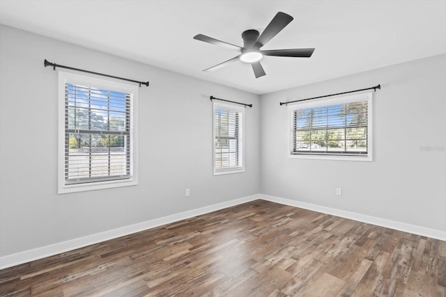 empty room featuring dark hardwood / wood-style floors and ceiling fan