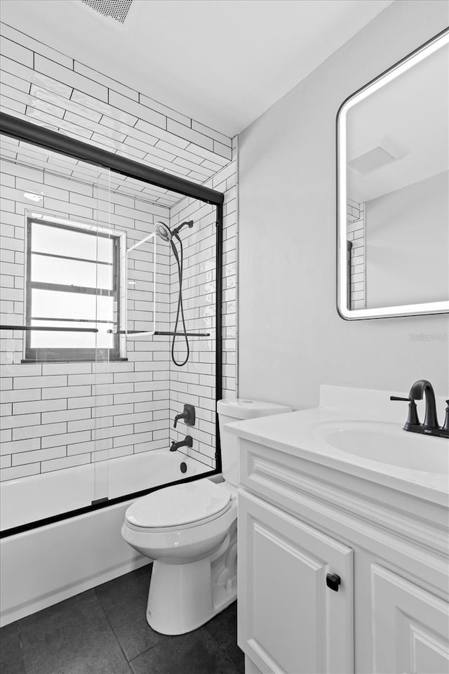 full bathroom with vanity, toilet, tile patterned flooring, and combined bath / shower with glass door