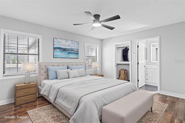 bedroom with connected bathroom, a walk in closet, dark hardwood / wood-style floors, a closet, and ceiling fan