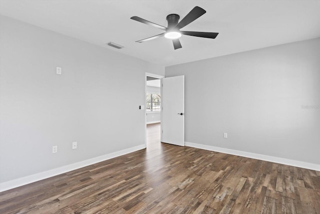 unfurnished room with ceiling fan and dark hardwood / wood-style flooring