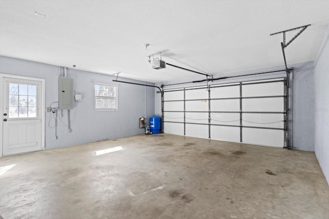 garage with a garage door opener and electric panel