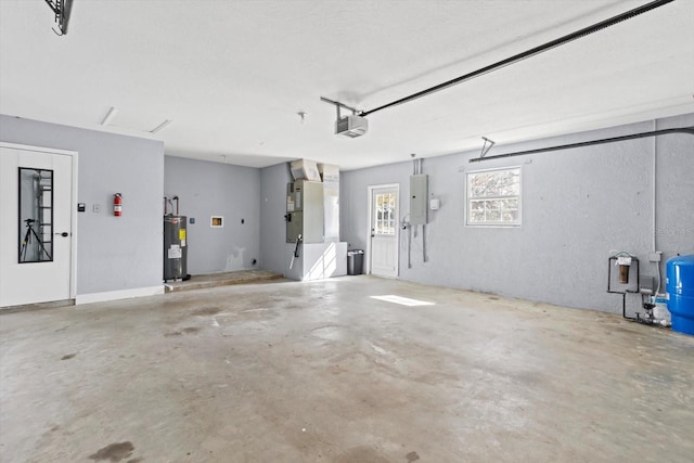 garage featuring heating unit, a garage door opener, electric panel, and electric water heater