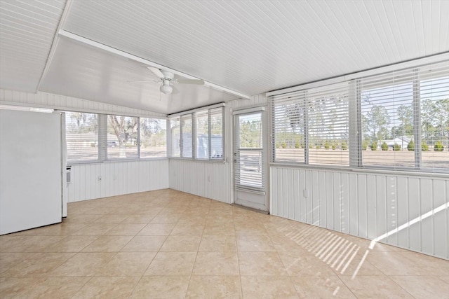 unfurnished sunroom featuring ceiling fan