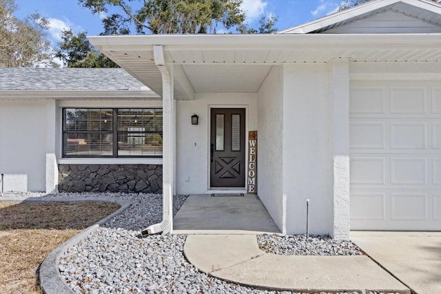 view of exterior entry with a garage