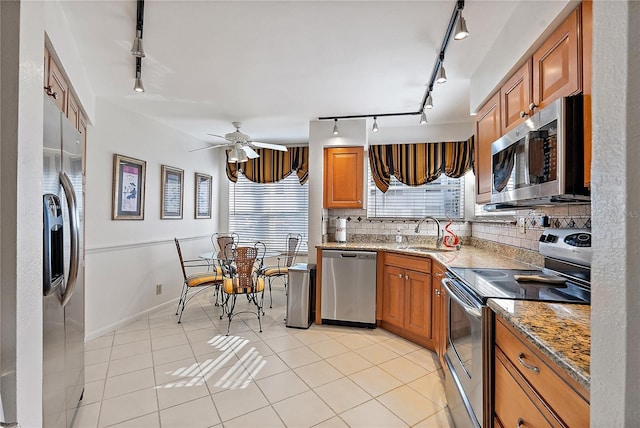 kitchen featuring a healthy amount of sunlight, stainless steel appliances, sink, and decorative backsplash