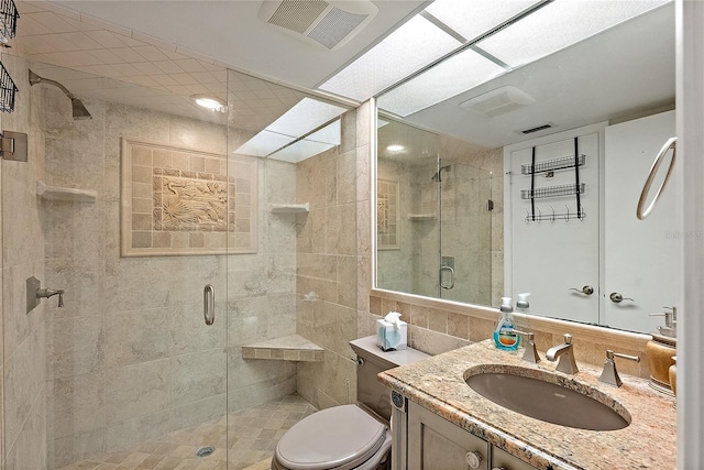 bathroom featuring toilet, tile walls, vanity, and walk in shower