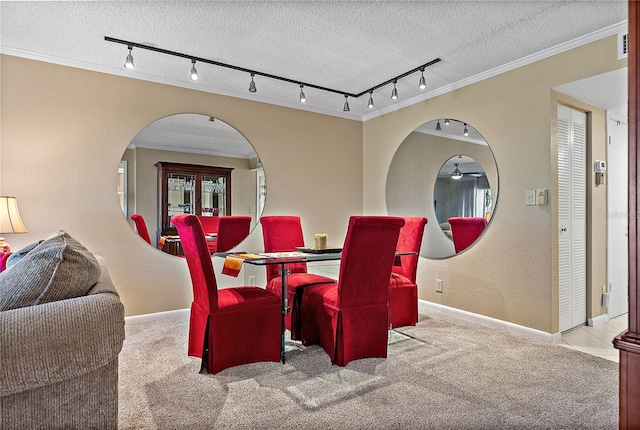 carpeted dining room with ornamental molding and a textured ceiling