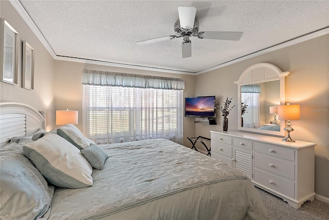 carpeted bedroom featuring ceiling fan, ornamental molding, and a textured ceiling