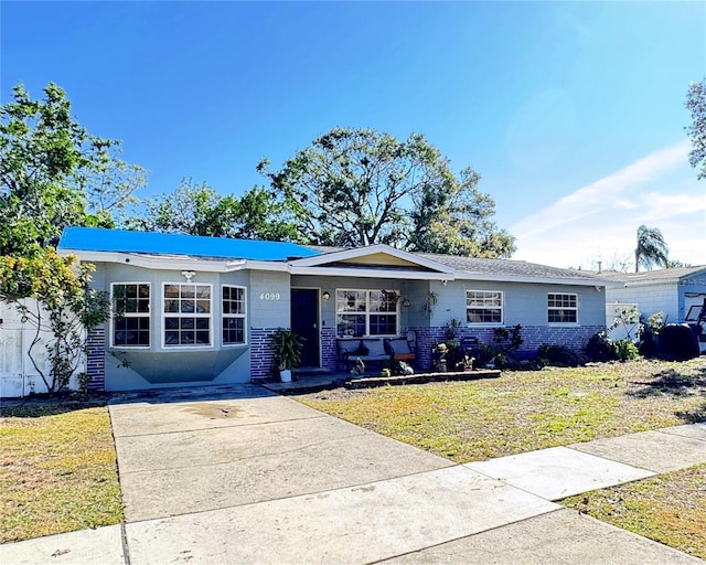 ranch-style house with a front lawn