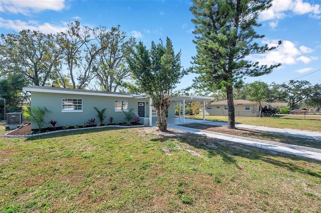 view of front of house with a carport, a front yard, and central air condition unit