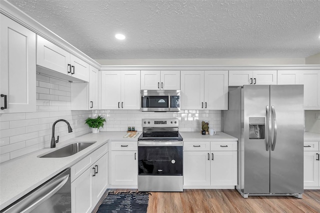 kitchen featuring white cabinetry, sink, and stainless steel appliances