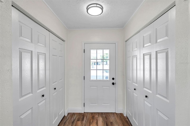 entryway with dark hardwood / wood-style flooring and a textured ceiling