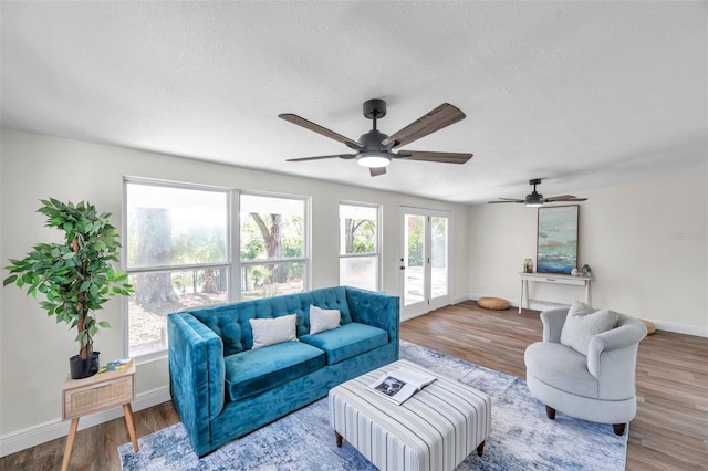 living room with hardwood / wood-style floors and a textured ceiling