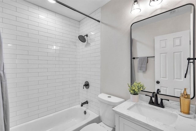 full bathroom featuring vanity, toilet, and tiled shower / bath