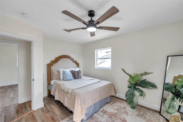 bedroom featuring wood-type flooring and ceiling fan