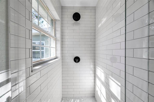 bathroom with a tile shower