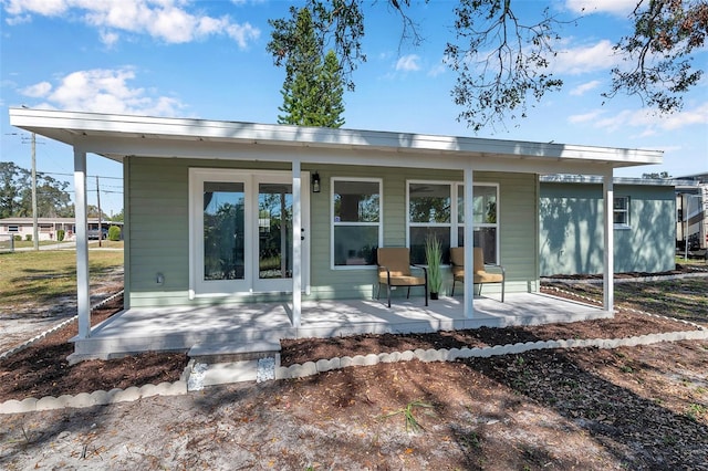 rear view of house featuring covered porch