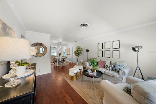 living room with dark wood-type flooring and ornamental molding