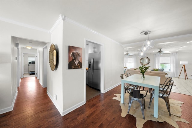 dining room featuring dark hardwood / wood-style flooring, ornamental molding, and ceiling fan