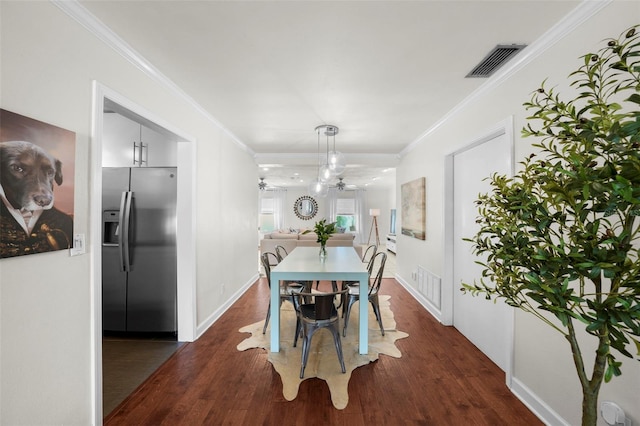 dining area with dark wood-type flooring, ornamental molding, and ceiling fan