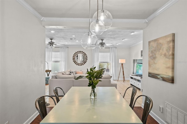 dining room with crown molding and ceiling fan