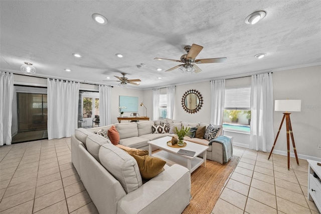 living room with crown molding, light tile patterned floors, a textured ceiling, and a wealth of natural light