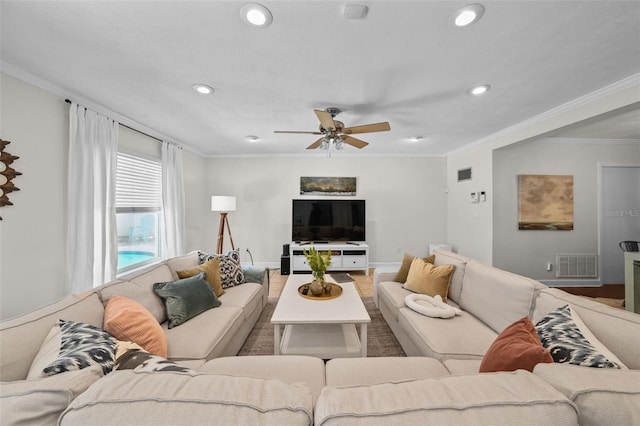 living room with crown molding and ceiling fan