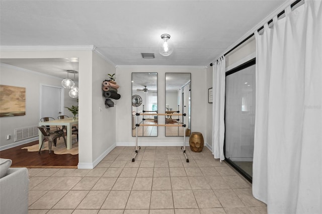 tiled foyer with ornamental molding