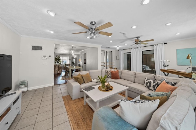 living room featuring light tile patterned flooring, ceiling fan, and crown molding