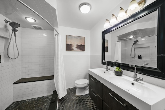 bathroom featuring walk in shower, toilet, tile patterned flooring, and tile walls