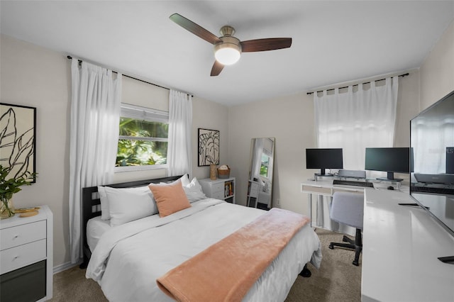 bedroom featuring ceiling fan and carpet