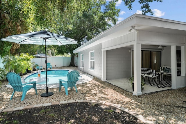 view of pool featuring ceiling fan and a patio