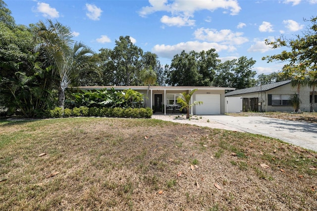 ranch-style house featuring a garage and a front yard