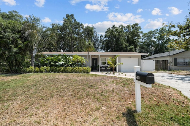 ranch-style house featuring a garage and a front yard