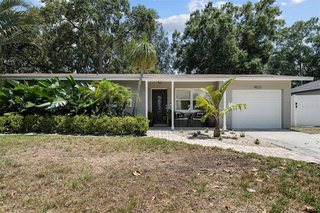 ranch-style house with a garage, a front lawn, and a porch