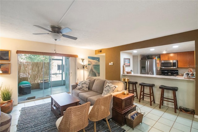 living room featuring light tile patterned floors and ceiling fan