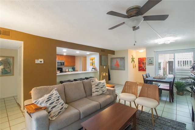 tiled living room with ceiling fan