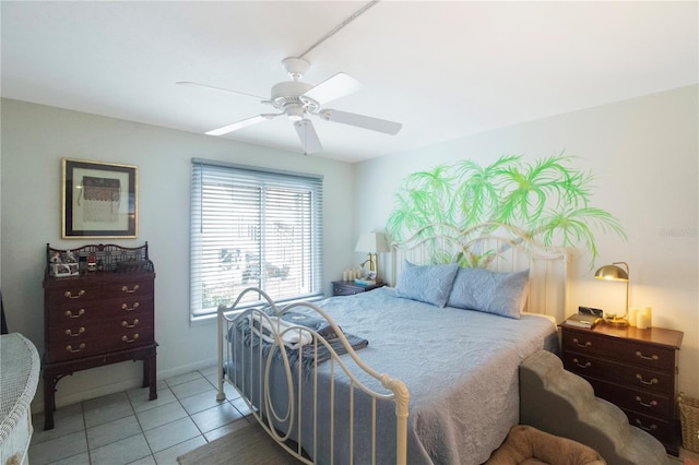 tiled bedroom featuring ceiling fan