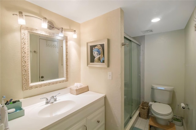 bathroom featuring walk in shower, vanity, and toilet