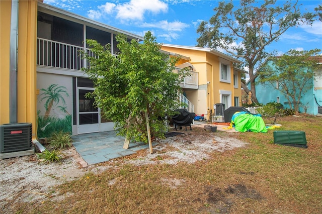 view of yard with cooling unit and a patio area