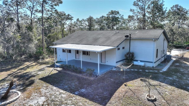 back of house featuring covered porch and central air condition unit