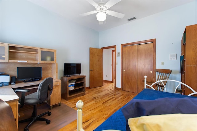 office with light hardwood / wood-style flooring and ceiling fan