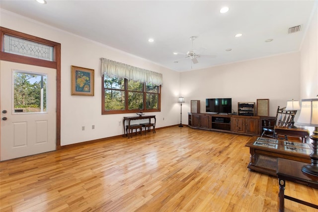 living room featuring ceiling fan, ornamental molding, and light hardwood / wood-style floors