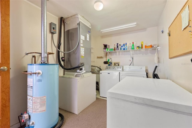 clothes washing area with washing machine and clothes dryer and gas water heater