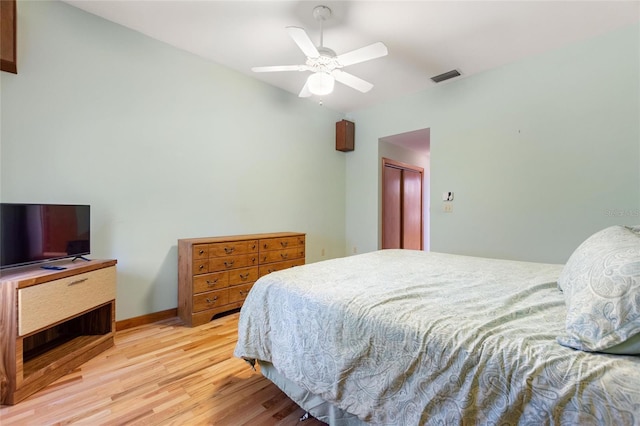 bedroom with a closet, ceiling fan, and light hardwood / wood-style flooring