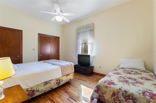 bedroom with ceiling fan and light wood-type flooring