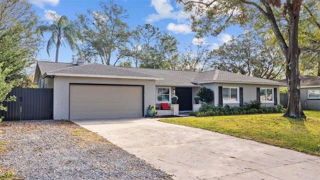 single story home with a garage and a front lawn